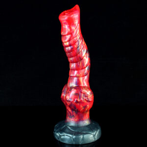 A close up of a red and black fantasy dildo.