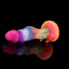 A vibrant, colorful dildo rests on a sleek black surface, showcasing its bright hues and playful design.