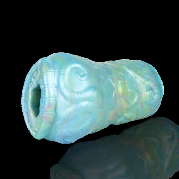 A blue and green masturbator with an opening that looks like a vagina. The sex toys is displayed in front of a black background.