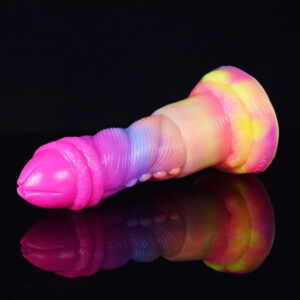 A vibrant dildo with a playful design of a penis, laying on a shiny, reflective surface.