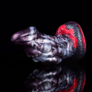 A close-up of a thick and girthy dragon dildo in front of a black background.