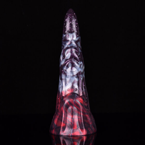 A fantasy dildo showcasing its bumps and ridges in front of a black background.