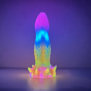 A dragon dildo standing on its suction cup, shining in various colors and brightening up the area around it.