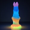 A glowing fantasy dildo standing on its suction cup brightening up a room. The dildo glows in purple, blue, orange and yellow.