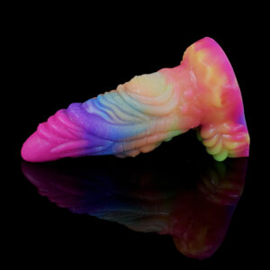 A playful looking fantasy dildo adorned with a bright rainbow pattern on a reflecting surface. The dildo has a lot of texture with ridges and a pointy tip.