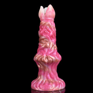 A pink fantasy dildo in front of a black surface.